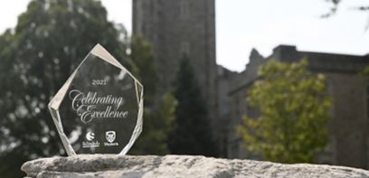 Glass award is displayed on dark background